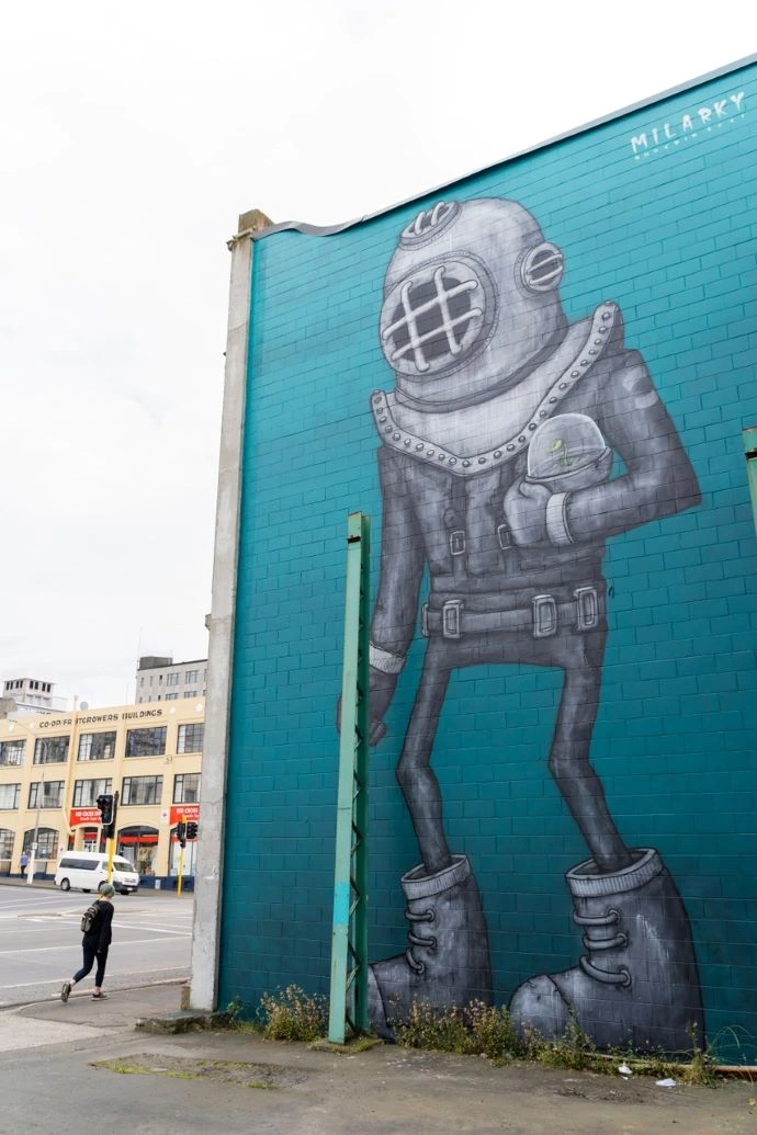 A large mural depicts a blue Aquanaut holding a plant.