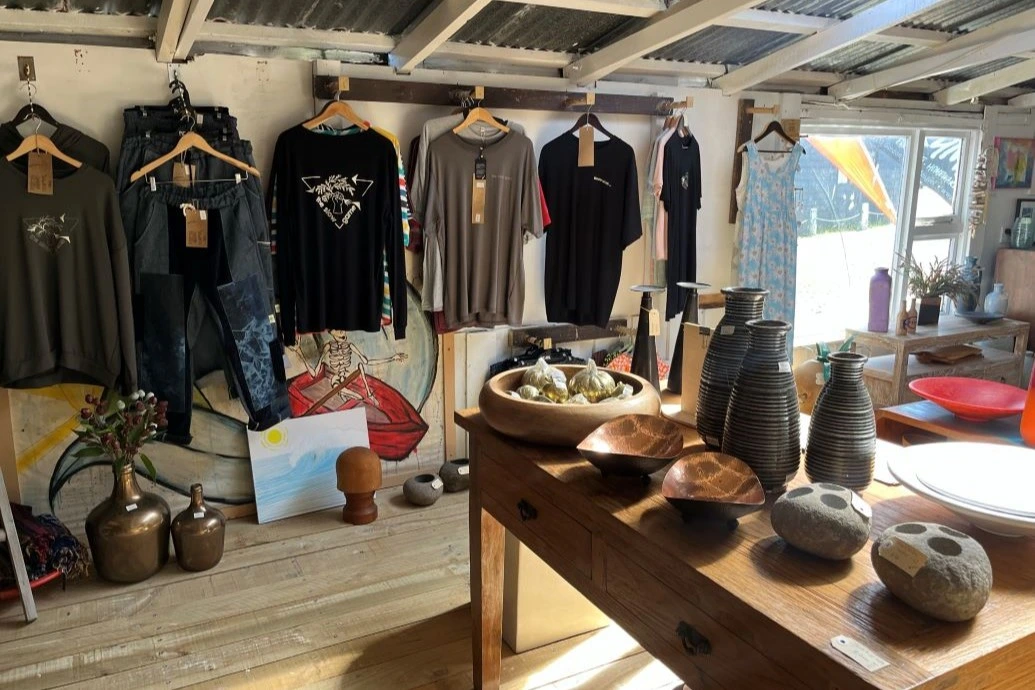 Apparel and home goods in the retail part of the boat shed.