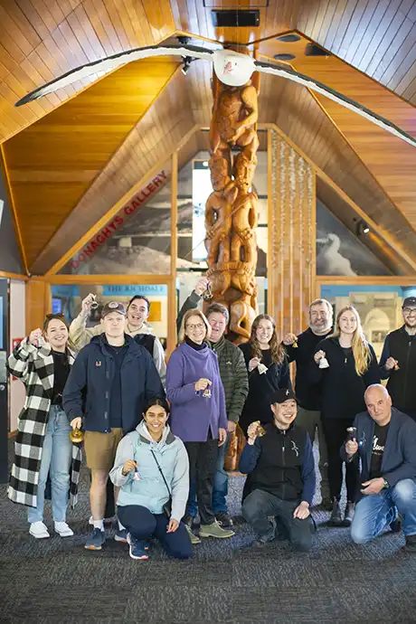 Group of people ringing bells standing in front of the Donaghys Gallery at the Albatross Centre