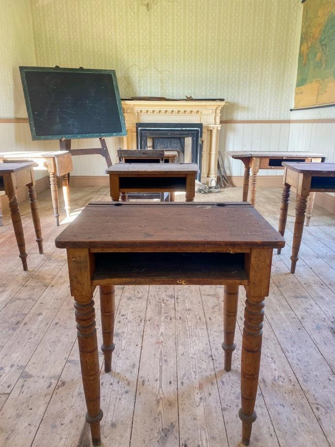 Desks inside the schoolhouse.