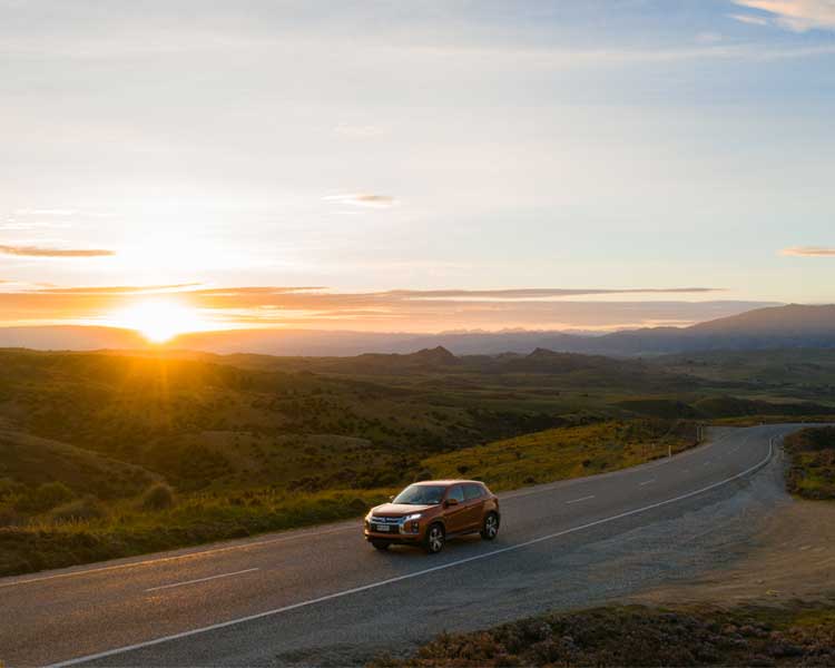 Car with sunset in background