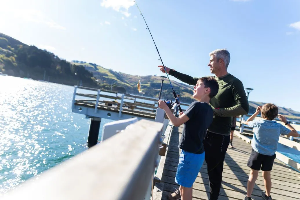 Boiler Point Fishing A father and son fishing at a wharf.